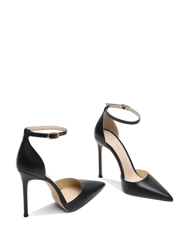 Black leather stiletto heels with pointed toes and ankle straps, featuring hollow sides.