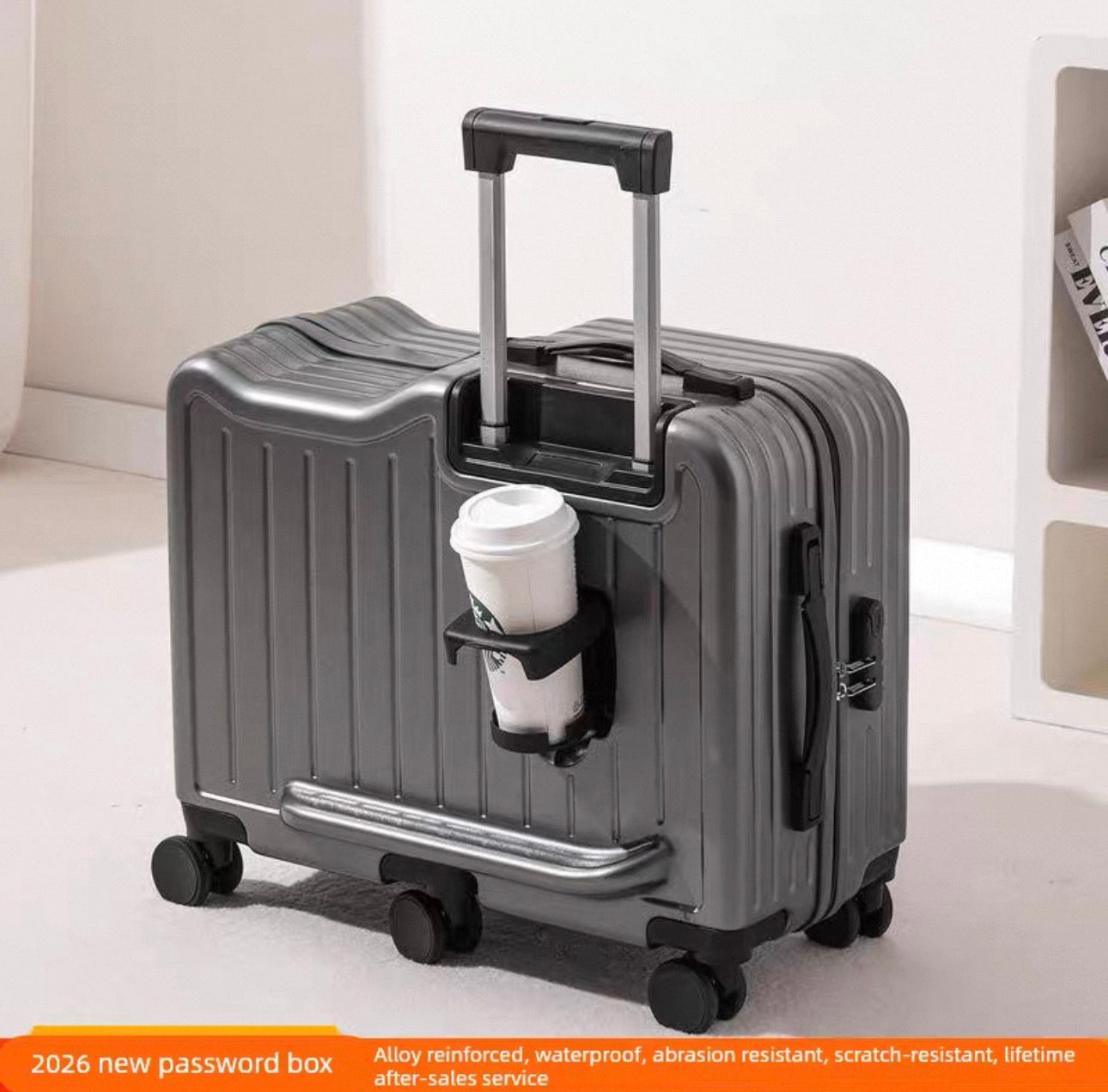 Gray suitcase with a cup holder containing a coffee cup on a light background