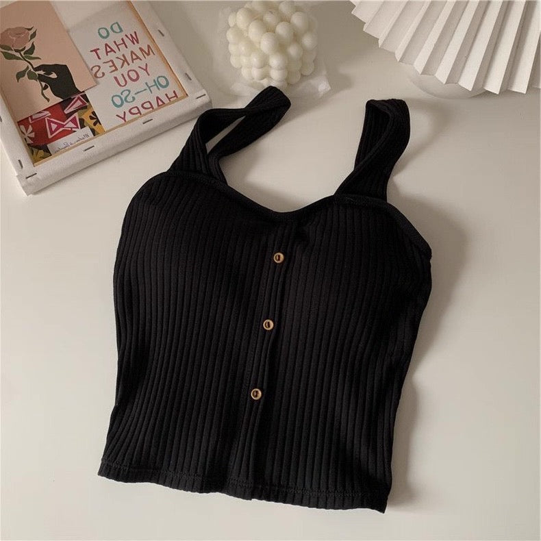 Black ribbed tank top with button details on a light surface
