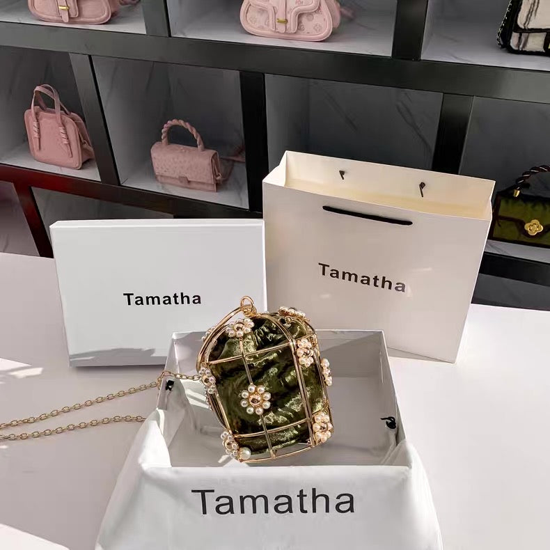 Pink handbags displayed on shelves with 'Tamatha' branding.