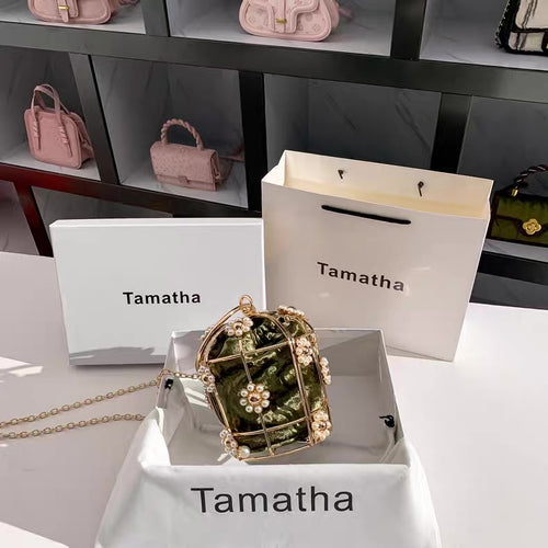 Pink handbags displayed on shelves with 'Tamatha' branding.