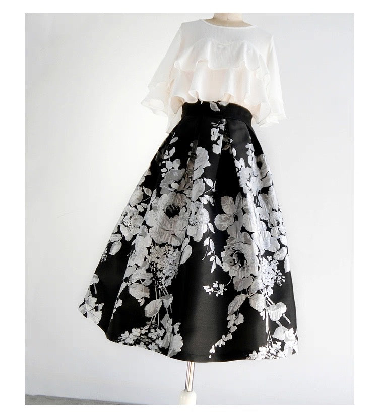 Black floral skirt on a mannequin with a white top against a light gray background