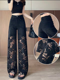 Black lace pants with a close-up of details worn by a person indoors.