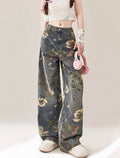 Person wearing floral jeans on a plain background
