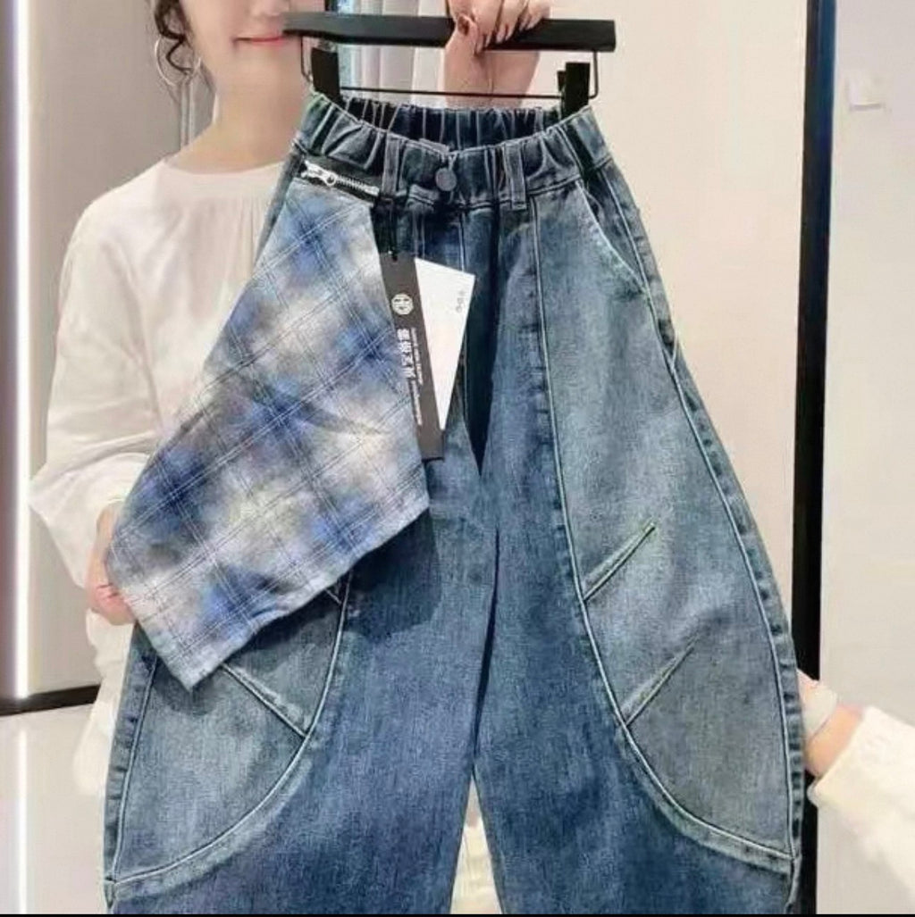 Blue denim pants on a hanger with a white background