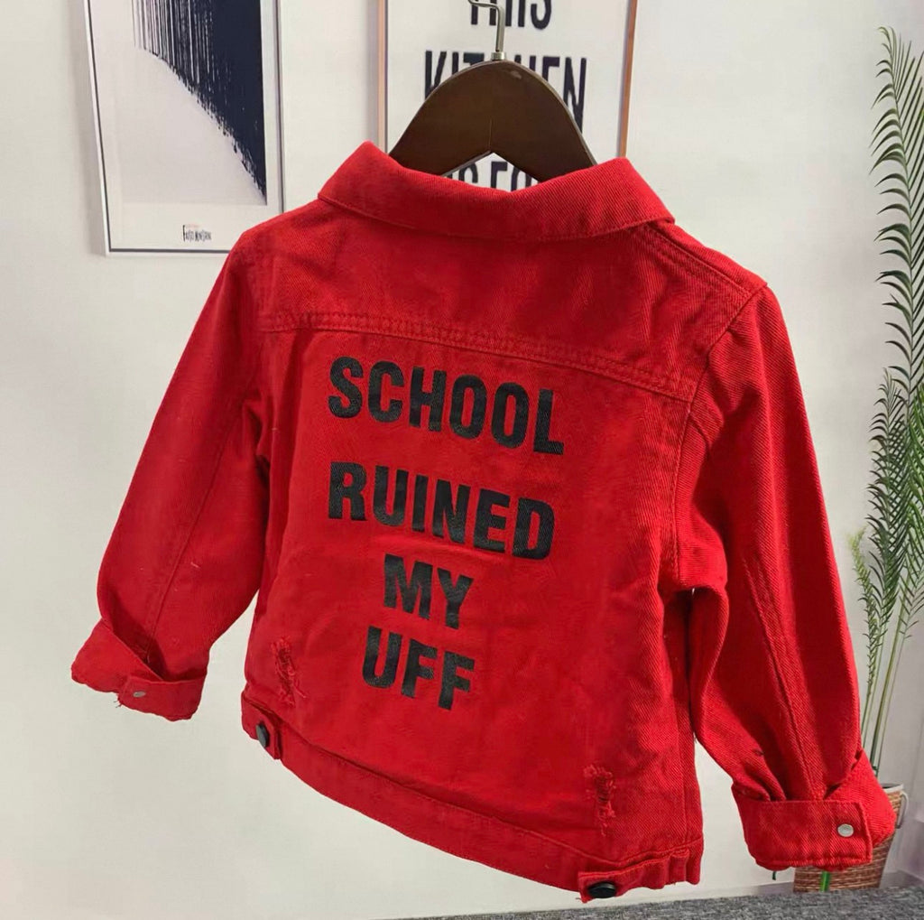 Red jacket with text 'SCHOOL RUINED MY UFF' on a hanger against a white wall.