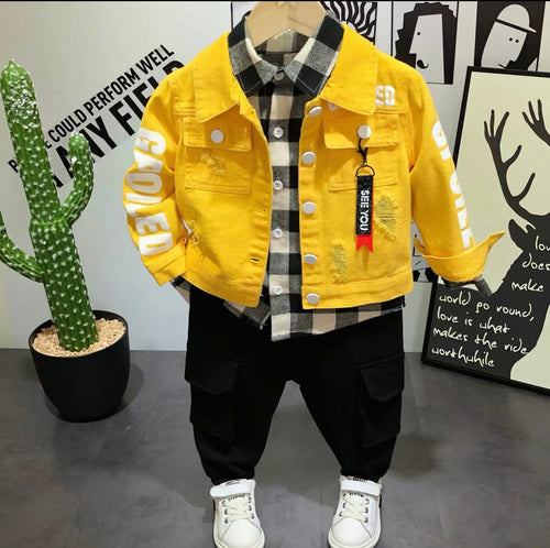 Yellow jacket with 'POWER' text on a mannequin against a wall with posters and a cactus plant.