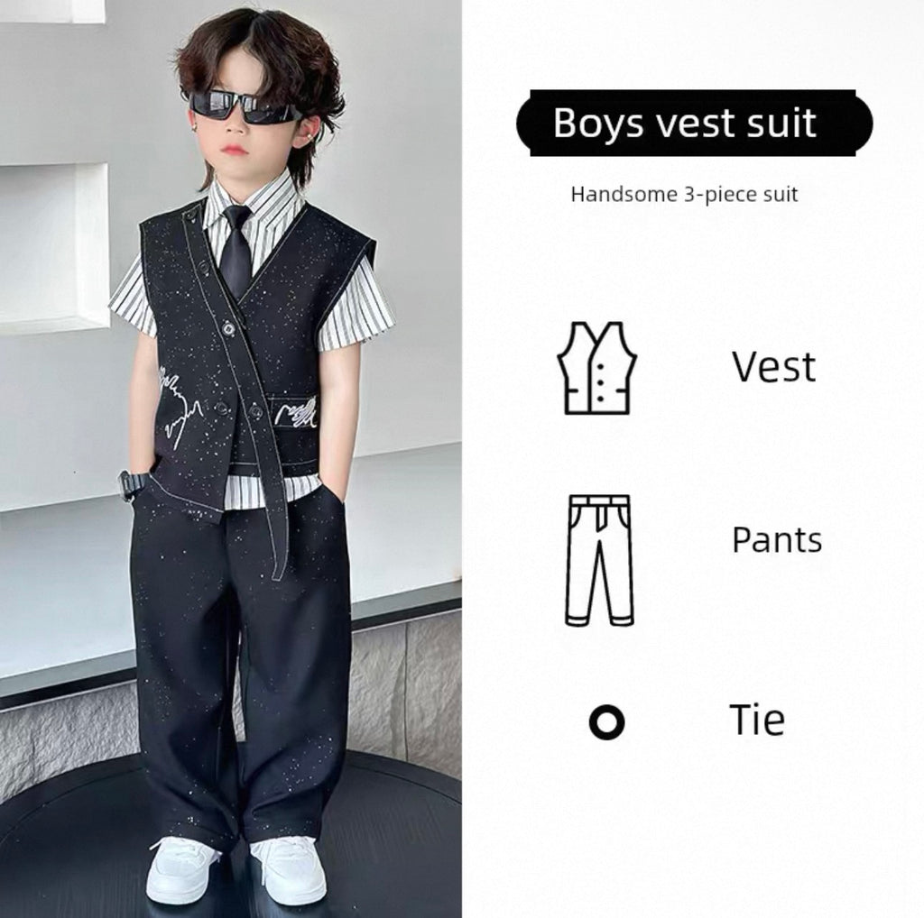 Young boy wearing a boys' vest suit with sunglasses, standing against a neutral background.