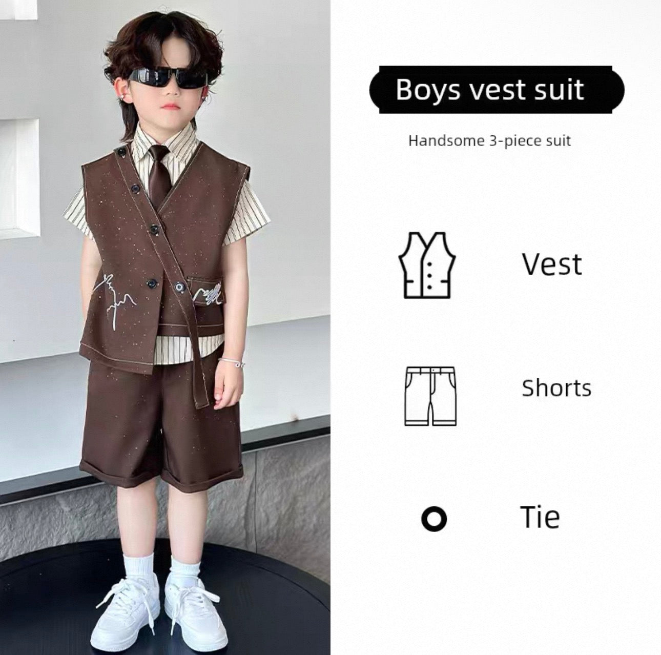 Child wearing a boys' vest suit with vest, shorts, and tie on a neutral background.