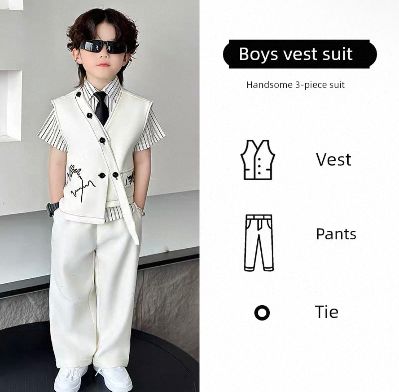 Young boy wearing a white vest suit with sunglasses, standing against a neutral background.