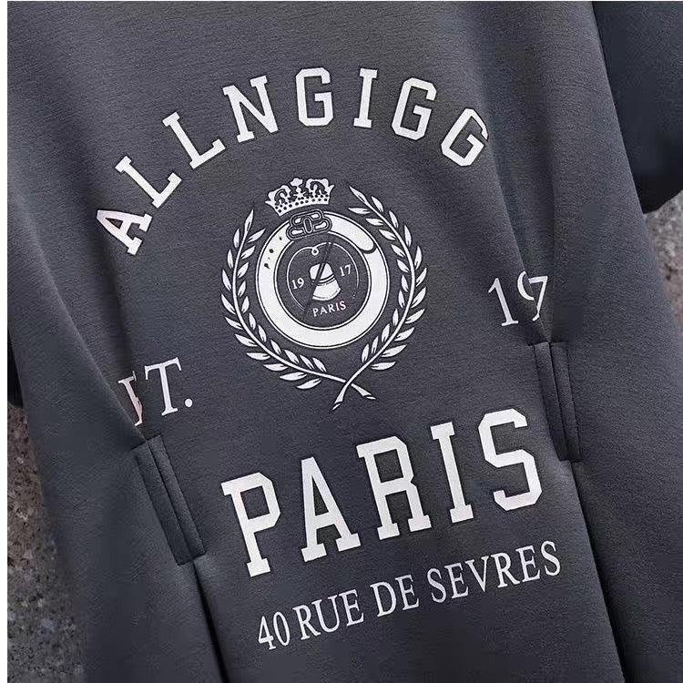 Gray sweatshirt with 'ALLNGIGG PARIS' text and logo on a textured surface