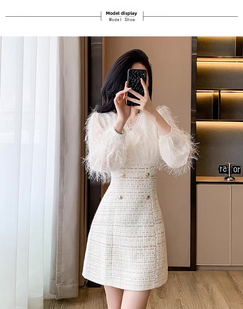 Woman taking a mirror selfie wearing a white dress with ruffled sleeves in an indoor setting.