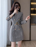 Woman wearing a patterned dress taking a mirror selfie.