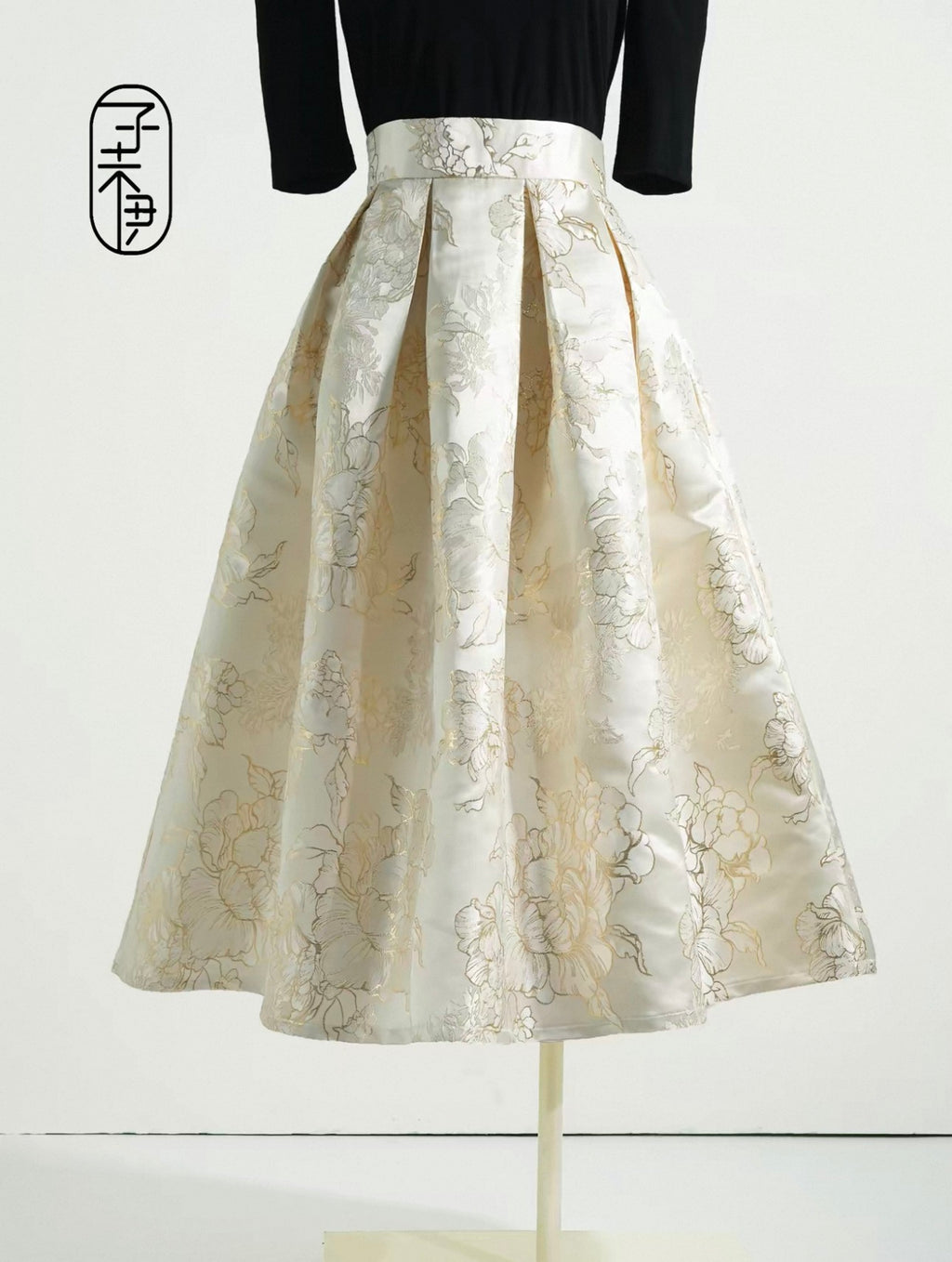 White floral skirt on a mannequin against a white background
