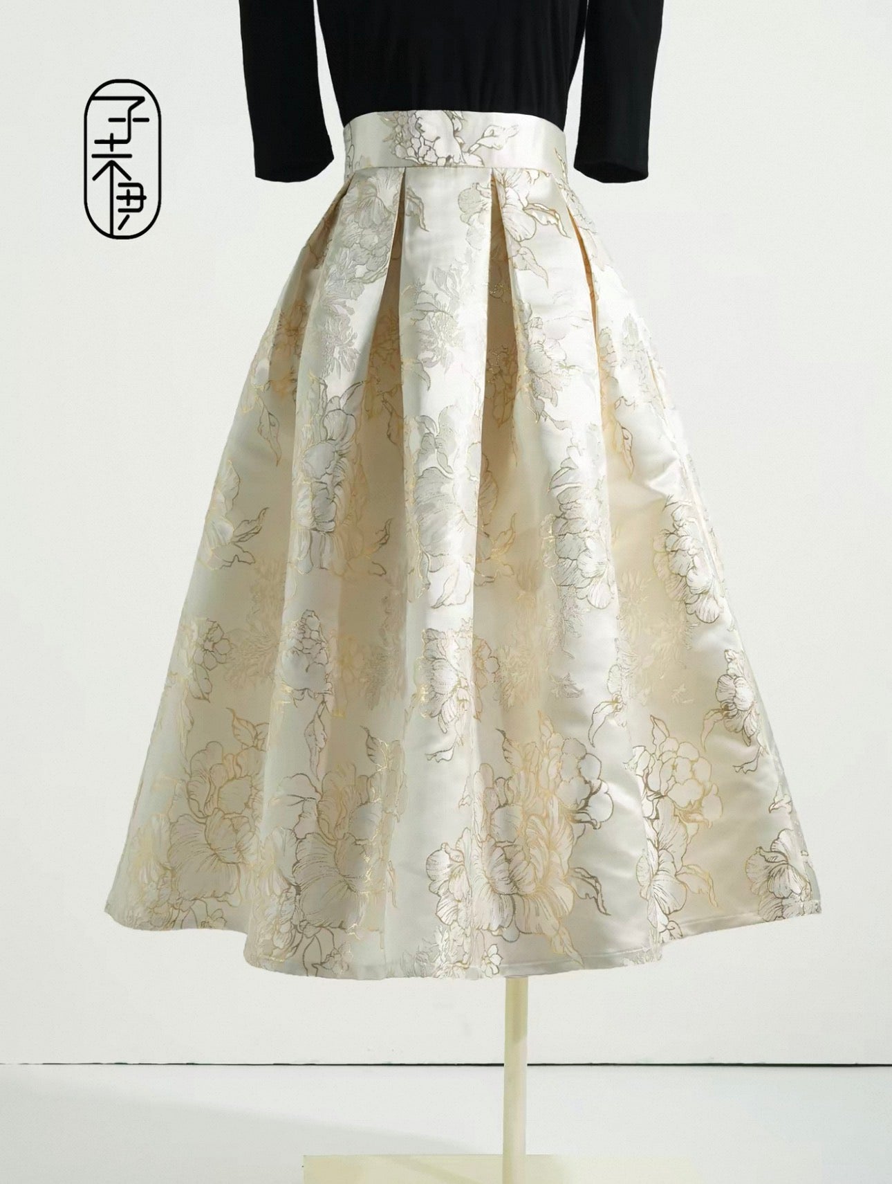 White floral skirt on a mannequin against a white background