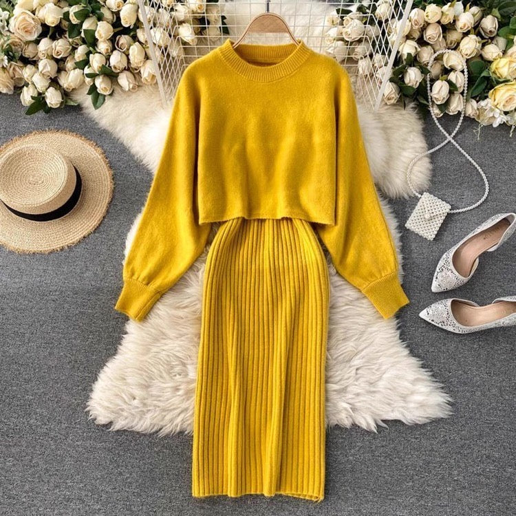 Yellow outfit with a skirt on a hanger, surrounded by decorative items like shoes and flowers.