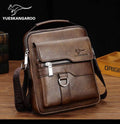Brown leather crossbody bag with visible YUESKANGAROO branding on a wooden surface.
