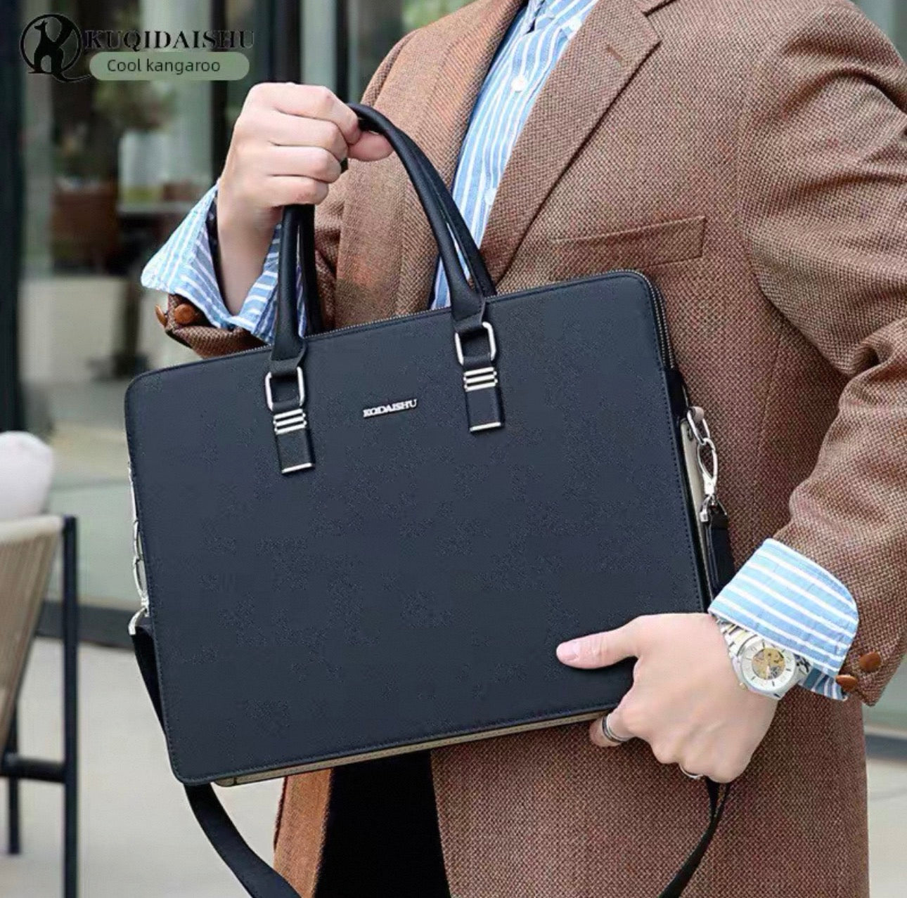 Person holding a black briefcase with a blurred background