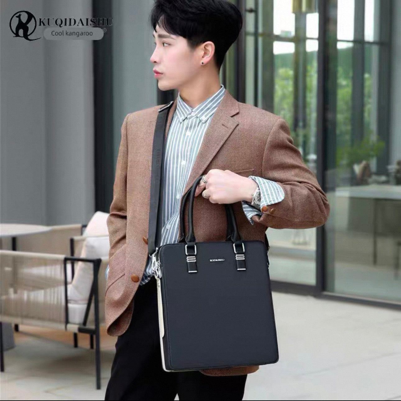 Man holding a black briefcase in an indoor setting