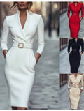 White dress with a belt on a blurred street background