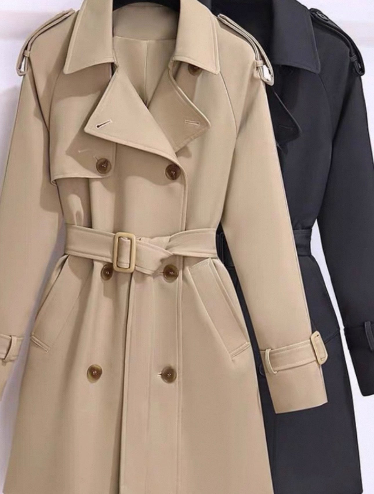 Beige trench coat with a belt and buttons on a white background