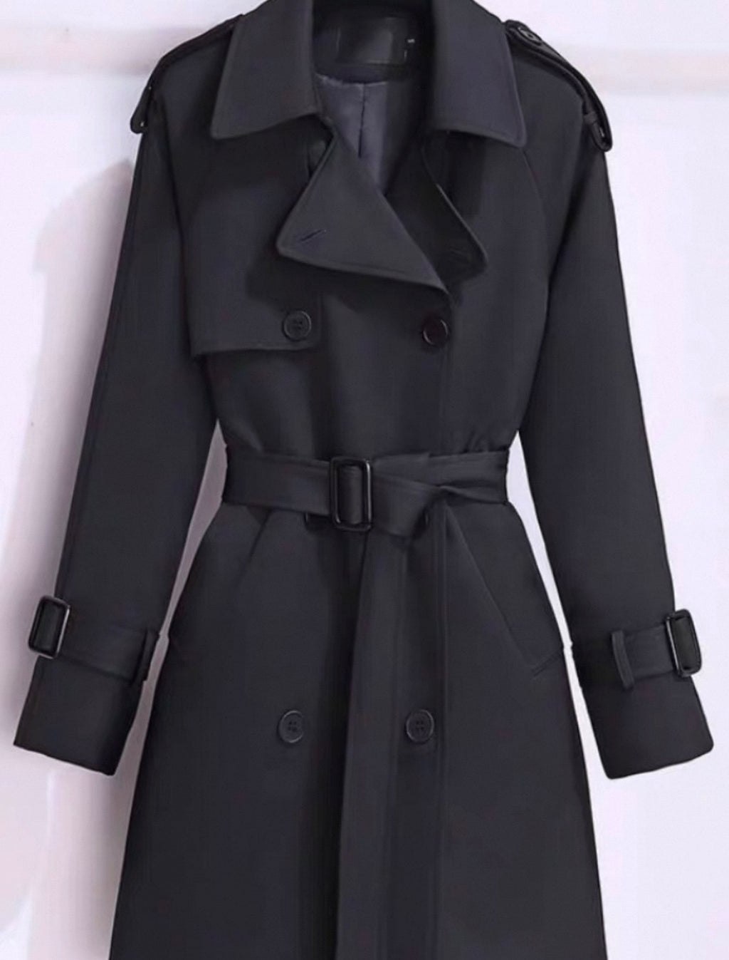 Black trench coat on a white background