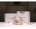 Pink handbag with decorative elements on a white surface with 'Mack Kevin' branding.