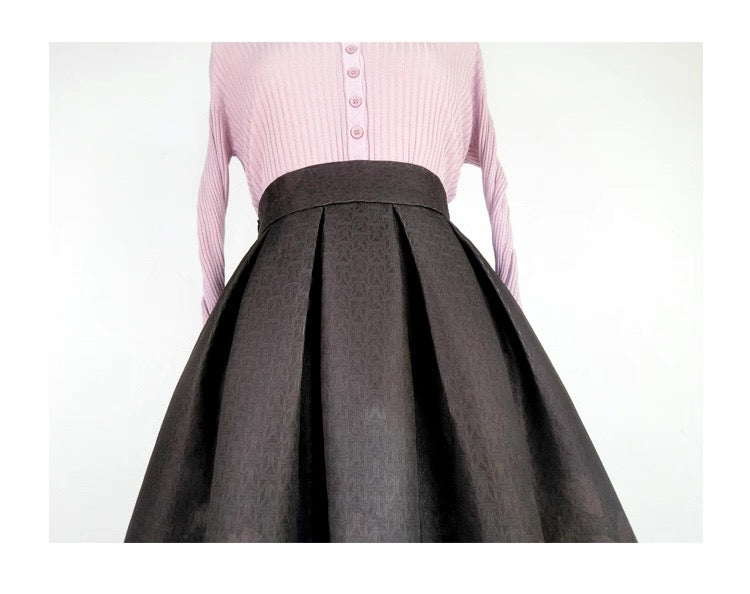 Pink shirt with a black pleated skirt on a white background