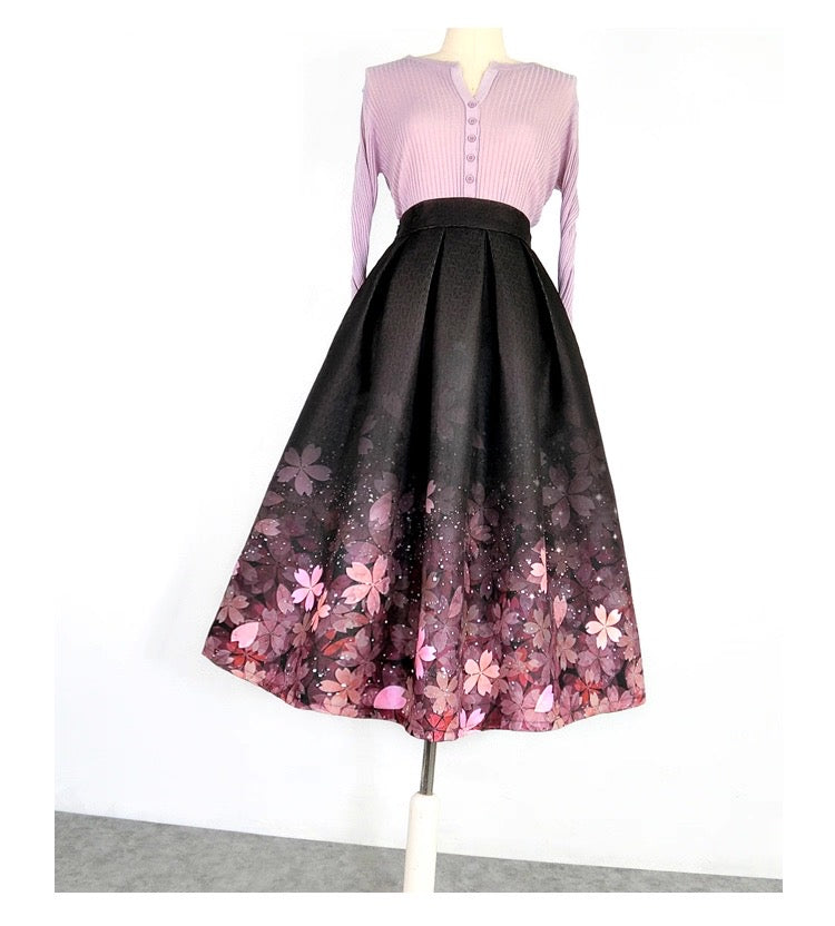 Mannequin wearing a pink top and black floral skirt on a white background