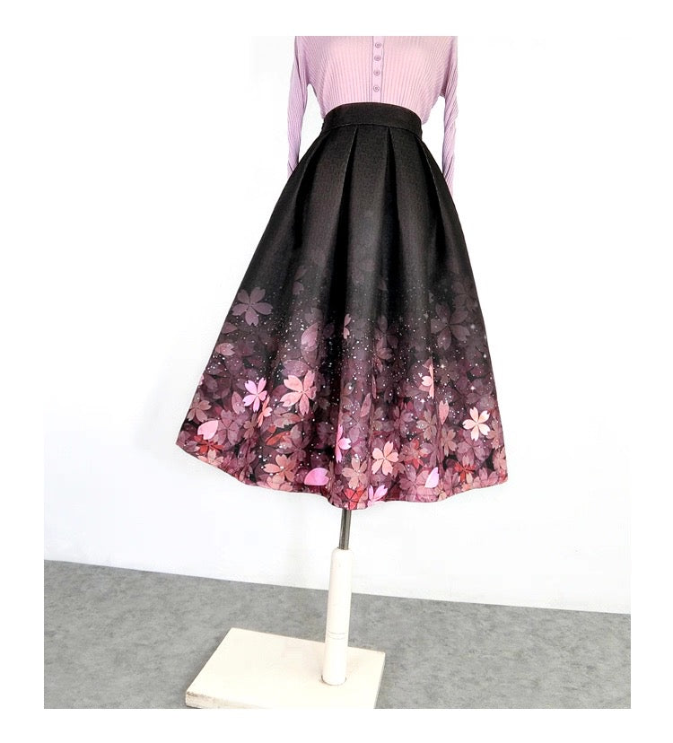 Black skirt with pink floral pattern on a mannequin against a white background