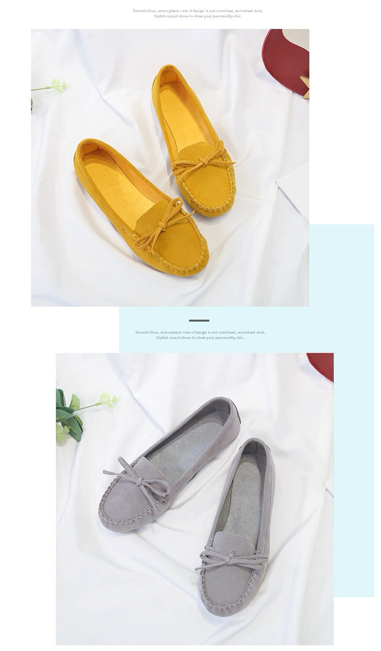 Yellow and gray loafers on a white background