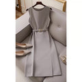 Gray dress with a belt on a hanger against a neutral background