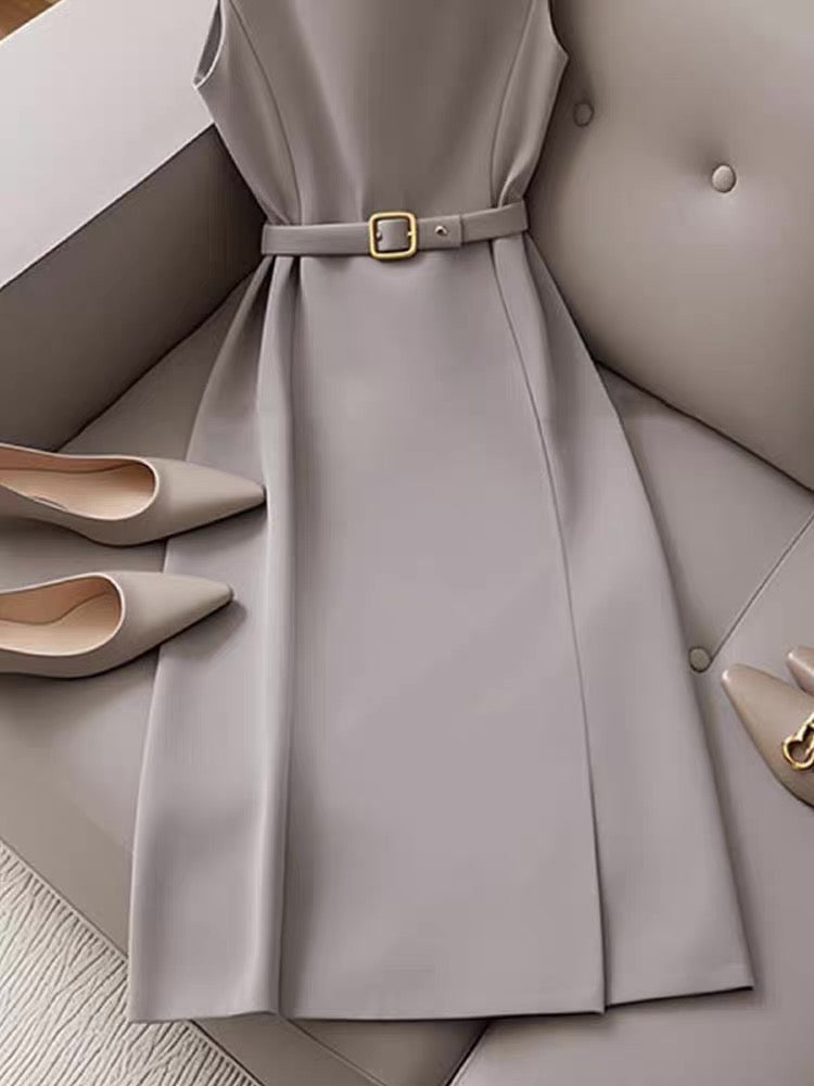 Gray dress with a belt and matching shoes on a neutral background