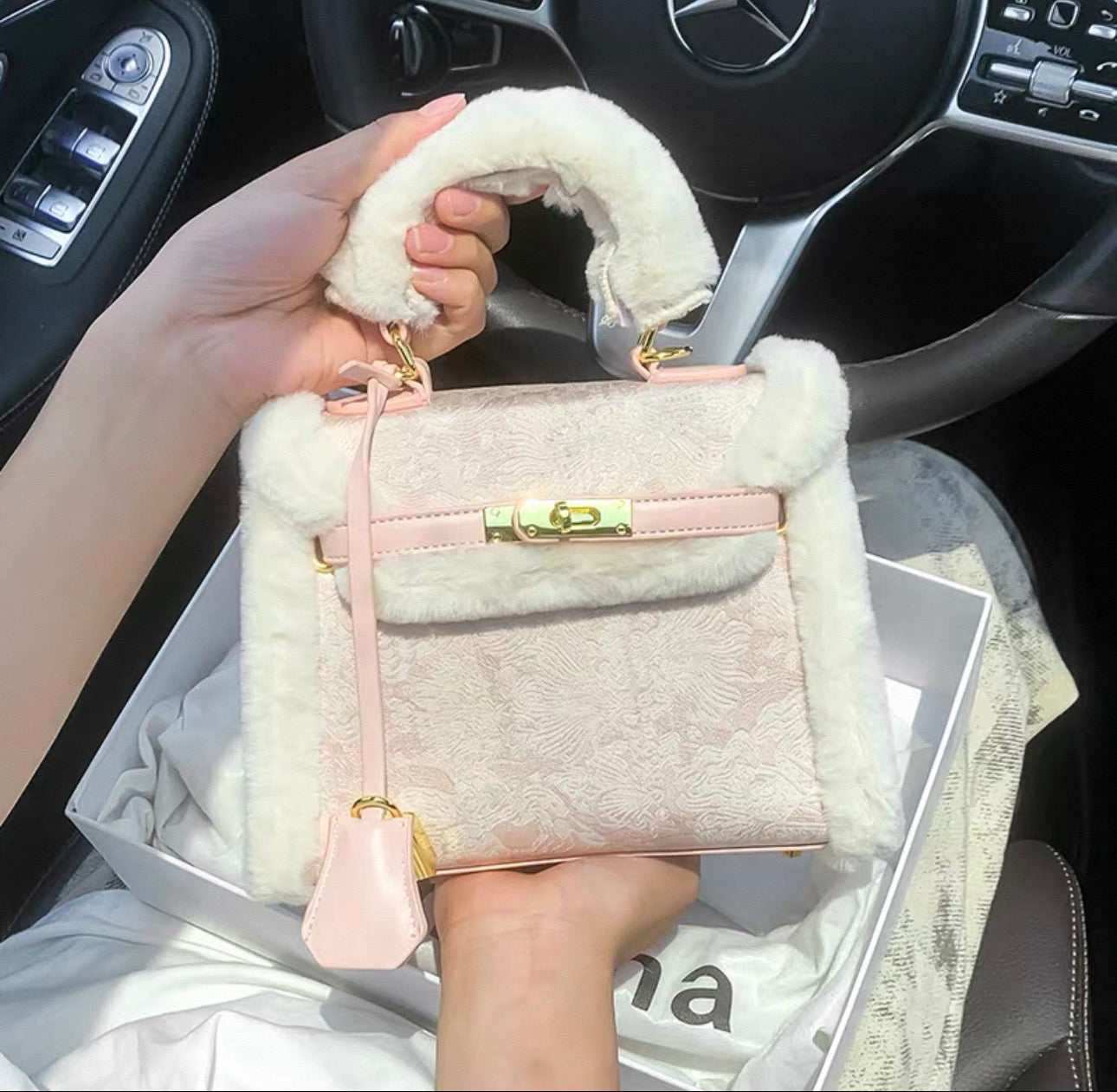 Light pink embroidered Kelly-style bag with gold clasp, soft fur-wrapped top handle, and detachable crossbody strap.