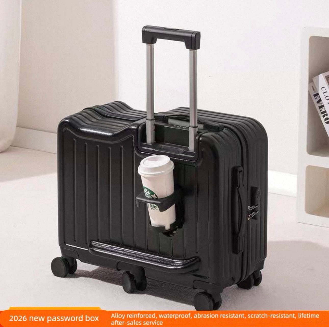 Black suitcase with a coffee cup holder containing a Starbucks cup on a light-colored floor.