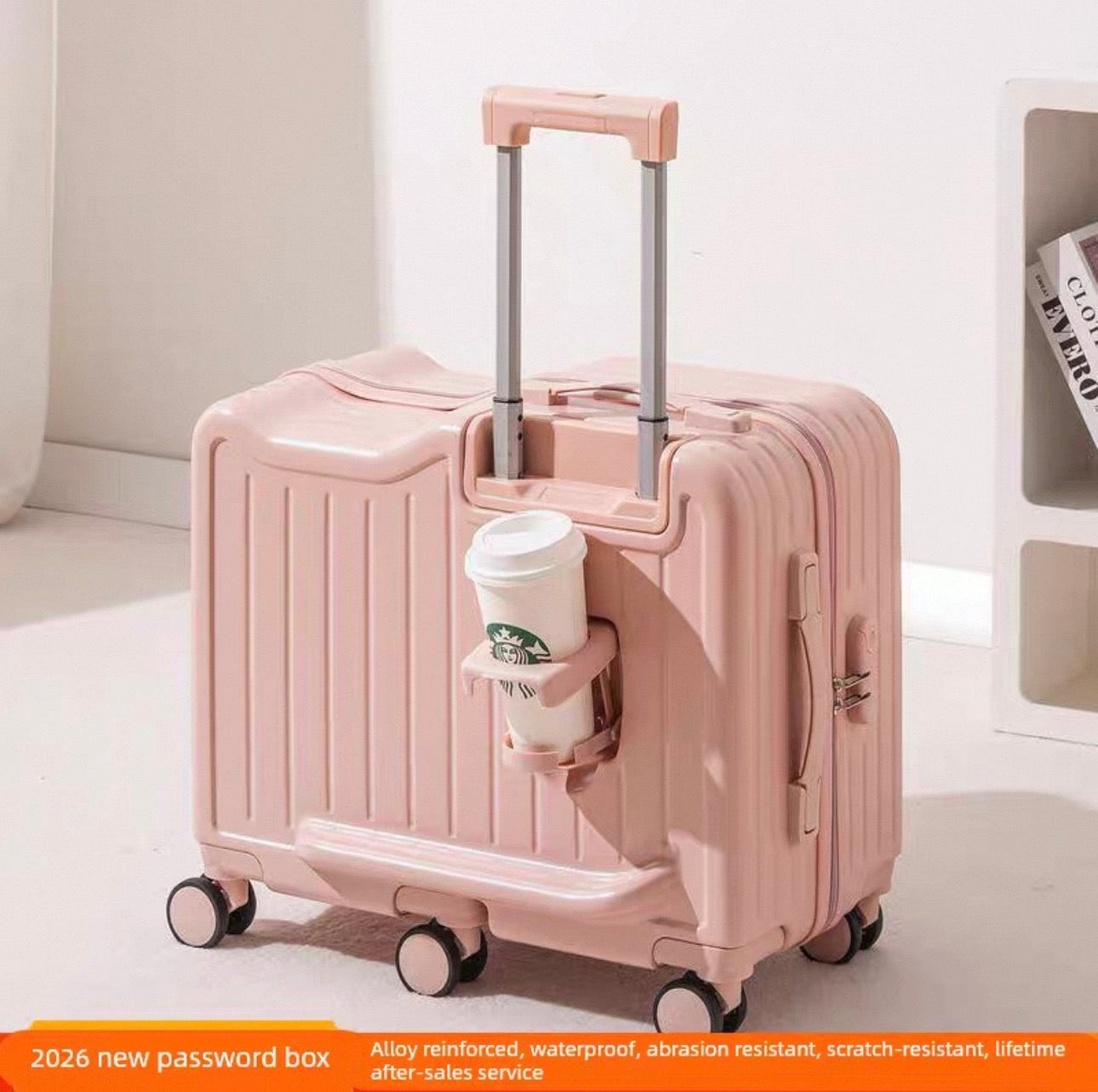 Pink suitcase with a cup holder holding a Starbucks cup on a light background