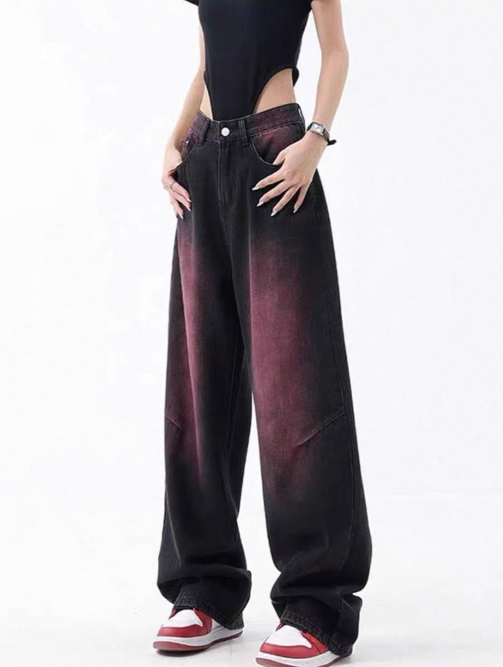 Person wearing wide-leg jeans on a white background