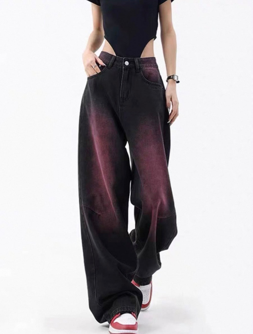 Person wearing black wide-leg jeans with a gradient effect on a white background