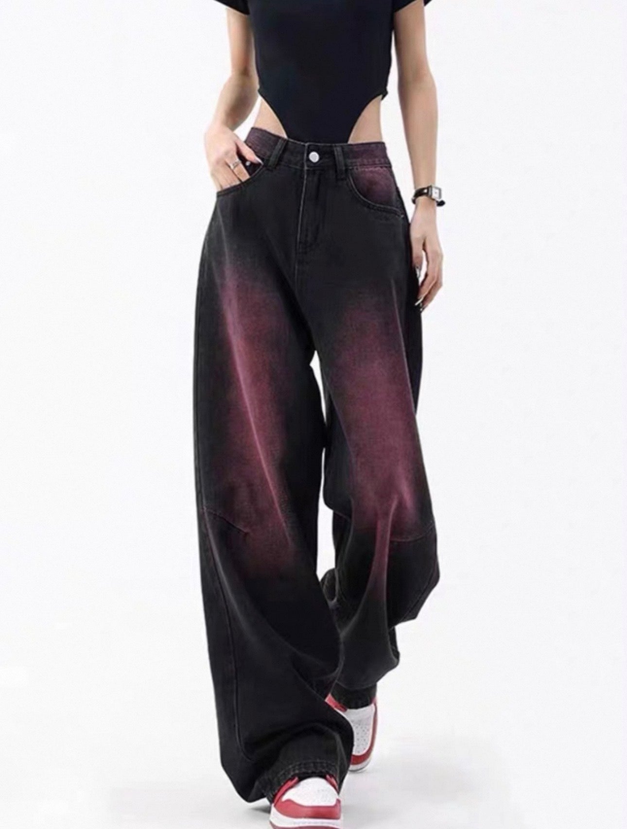 Person wearing black wide-leg jeans with a gradient effect on a white background