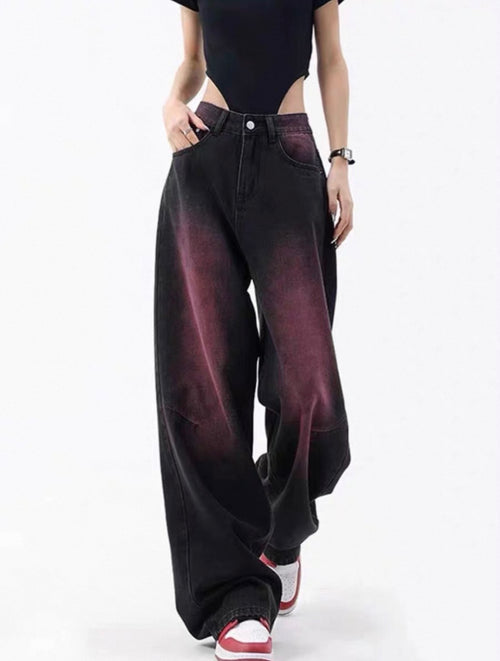 Person wearing black wide-leg jeans with a gradient effect on a white background