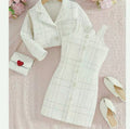 White checkered outfit with a matching dress, jacket, and shoes on a pink floral background.
