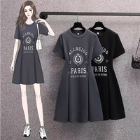 Black dress with 'ALLINGGG PARIS' print displayed on a rack with a woman wearing the dress.