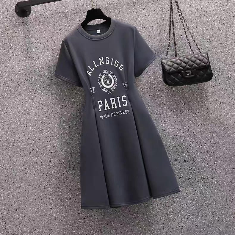 Gray dress with 'ALLNGIGG PARIS' text and a black handbag on a textured surface