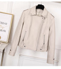 Beige leather jacket on a mannequin against a white wall with a framed picture.